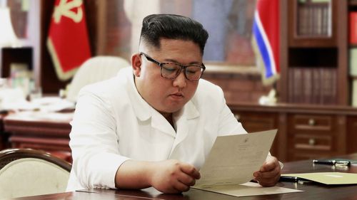 North Korean leader Kim Jong Un reads a letter from U.S. President Donald Trump.