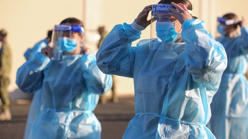 Australian Defence Force members Seaman Chloe Baker and Seaman Tamsin Conway practice correct application of Personal Protective Equipment (PPE) in preparation for their deployment in Task Unit 3, on the Joint Task Force 629.2, Operation COVID-19 Assist