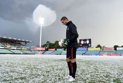 Players inspect the pitch after the storm had passed. (AAP)