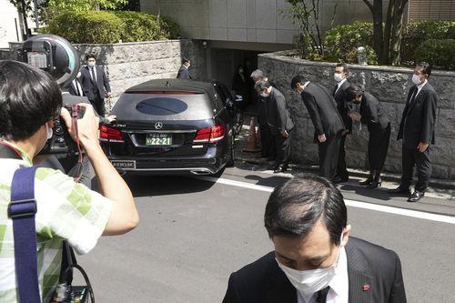 A hearse which is believed to carry the body of former Prime Minister Shinzo Abe, arrives at his home Saturday, July 9, 2022, in Tokyo 