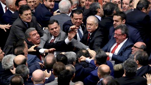 Turkey president Erdogan rebukes MPs over 'leg-biting' brawl in parliament