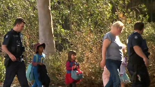 Children from a local primary school evacuate after the campus was thrown into lockdown.