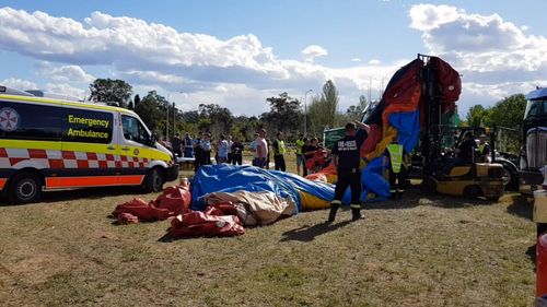 Three children were injured when the jumping castle they were playing on flipped into the air.