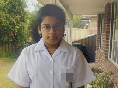 Author standing outside, wearing school uniform