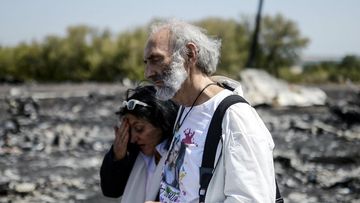 Angela Rudhart-Dyczynski and Jerzy Dyczynski from Australia react as they arrive on July 26, 2014 at the crash site of the Malaysia Airlines Flight MH17 where they lost their 25 years old daughter. (Getty)
