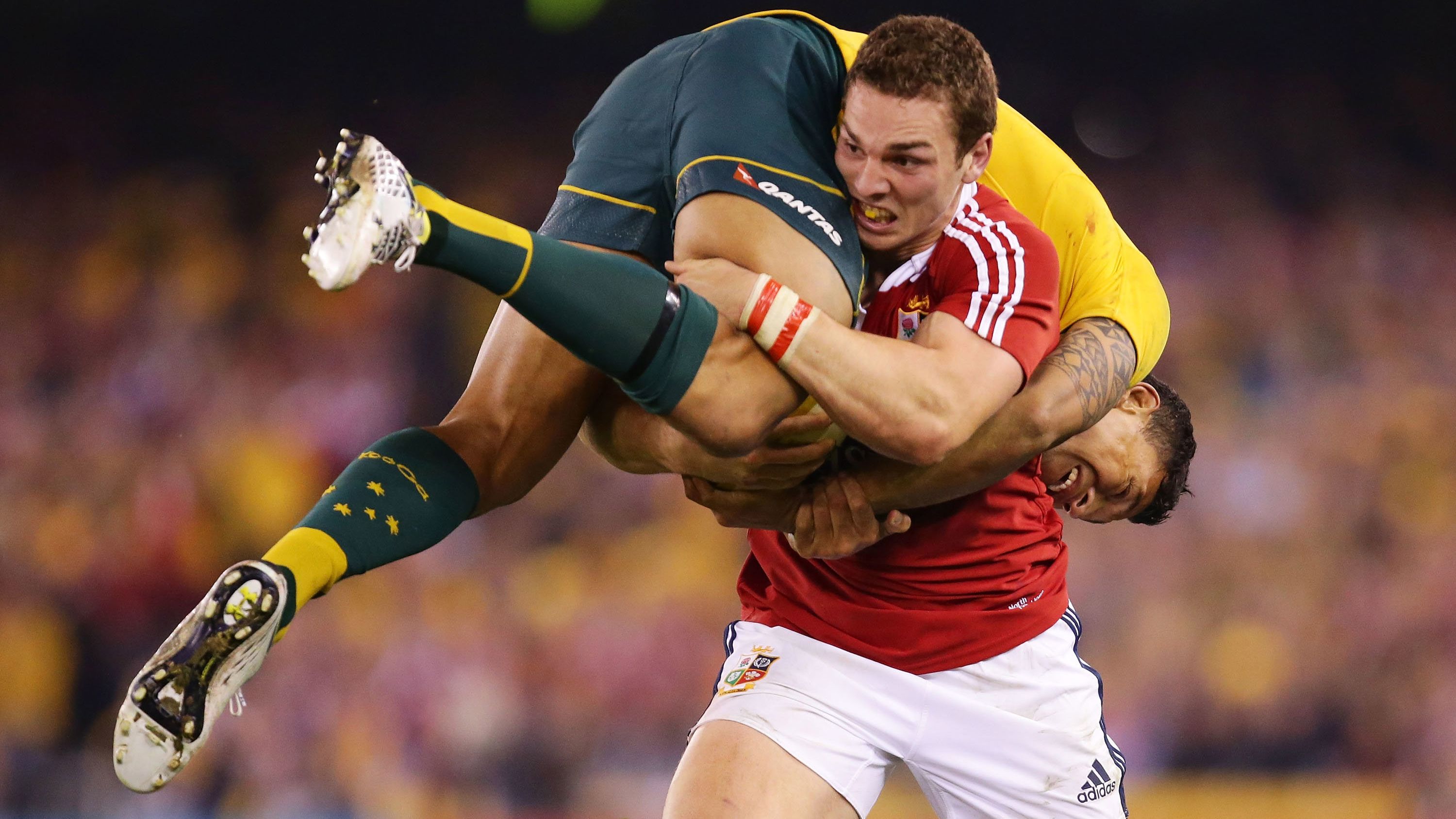 George North of the Lions carries Israel Folau of the Wallabies.