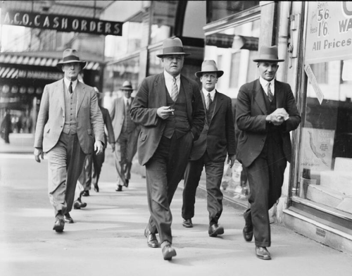 Sydney Police Detective Sergeant Thomas McRae (centre) walks down a street with three police officials, Sydney, 20 March 1933. McRae was one of the lead detectives on the cases.