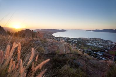 Sunset view of Townsville, Queensland, Australia looking from Castle Hill towards the coast and calm sea.