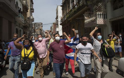 Anti-government protesters march in Havana, Cuba on Sunday, July 11, 2021. (AP Photo/Ismael Francisco)