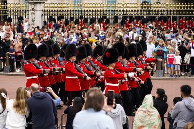 Spectators attend the first Changing the Guard outside Buckingham Palace, since the beginning of the Covid19 pandemic, in London.