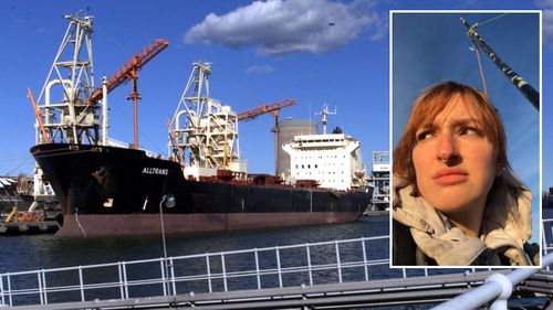 An activist has shut down coal operations at the Port of Newcastle by attaching herself to a bridge.
