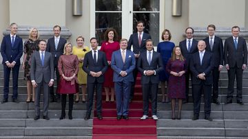 Prime Minister Mark Rute, centre left, and Dutch King Willem-Alexander, centre, pose with the ministers for the official photo of the new Dutch government on the steps of Royal Palace Noordeinde in The Hague, Netherlands (Photo: October 2017)