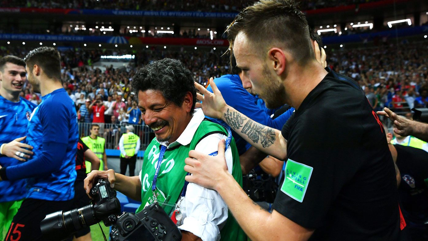 AFP photographer Yuri Cortez is comforted by Croatian player Ivan Rakitic.