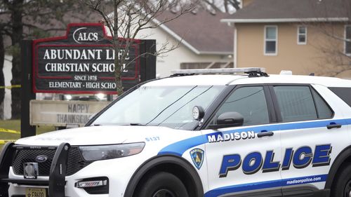 Emergency vehicles are parked outside the Abundant Life Christian School in Madison, Wis., where multiple injuries were reported following a shooting, Monday, Dec. 16, 2024. (AP Photo/Morry Gash)