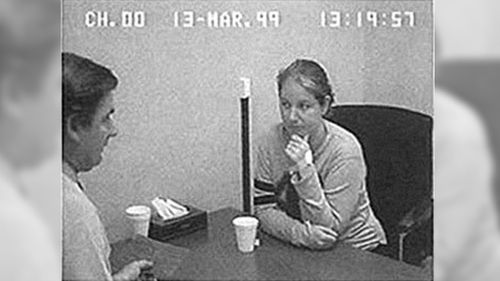 Robertson speaks with police following her arrest in 1999.