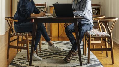 Couple sitting at table working from home