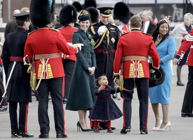 Catherine, Duchess of Cambridge and Prince William, Duke of Cambridge smile and laugh after Lieutenant Colonel Rob Money puts a bearskin hat on his 20-month-old daughter Gaia Money's head as they attend the 1st Battalion Irish Guards' St. Patrick's Day Parade at Mons Barracks on March 17, 2022 in Aldershot, England.  