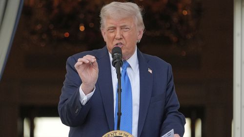 President Donald Trump speaks during a summer soiree on the South Lawn of the White House. He has banned the citizens of 12 countries from travelling to the US.