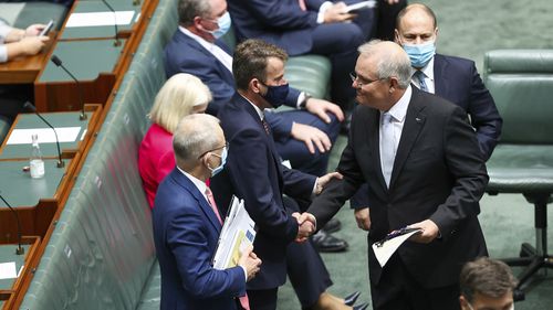 Prime Minister Scott Morrison is congratulated by his frontbench after delivering his speech.