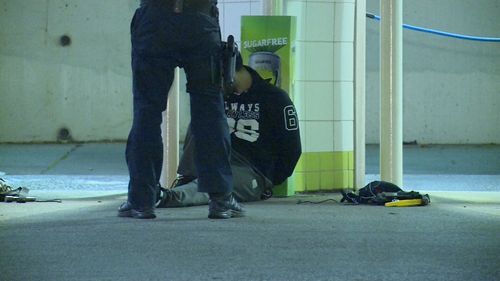 One of the men handcuffed by police at the station. 