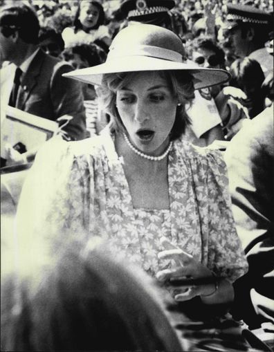 Princess Diana startled when flowers are thrown at her as she leaves the Sydney Opera House.