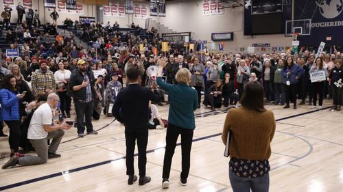 Elizabeth Warren speaks to a caucus crowd before the vote.