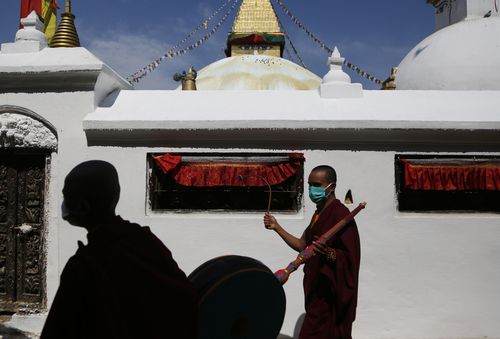 Buddhist monks participate in a parade to mark Buddha Jayanti festival, during lockdown at Boudhanath Stupa in Kathmandu, Nepal