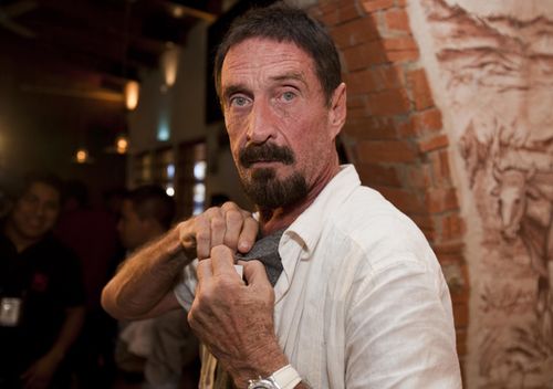 Software company founder John McAfee adjusts a microphone in preparation for an interview in Guatemala City.
