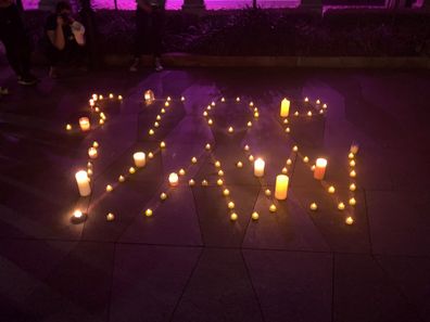 Tea candles were used to spell out STOP VAW (stop violence against women).