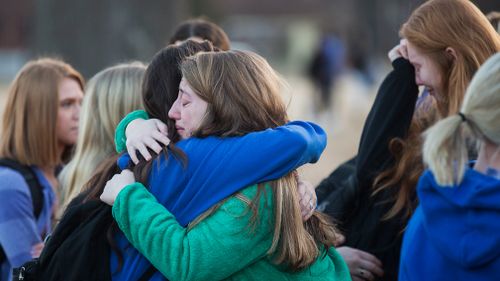 Students embrace following a prayer vigil at Paducah Tilghman High School in Paducah, Kentucky. (AAP)