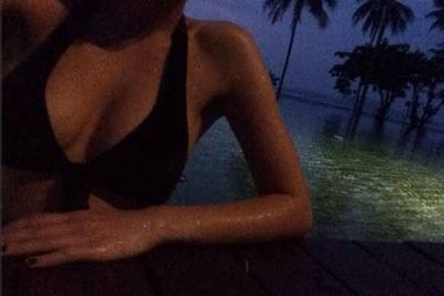 Apparently, the no-head shots are popular this holiday season. This is Jesinta Campbell in Thailand, enjoying a moonlit swim.