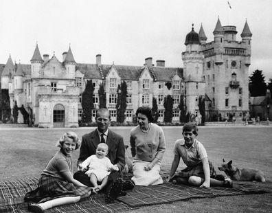In this 1960 photo, Queen Elizabeth, Prince Philip and their children, Prince Charles,  Princess Anne and Prince Andrew sit on the lawn of Balmoral Castle