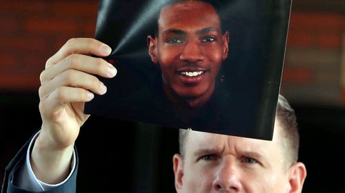 Bobby DiCello holds up a photograph of Jayland Walker