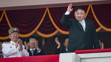 North Korean leader Kim Jong-Un (R) waves from a balcony of the Grand People&#x27;s Study house following a military parade marking the 105th anniversary of the birth of late North Korean leader Kim Il-Sung, in Pyongyang on April 15, 2017.  