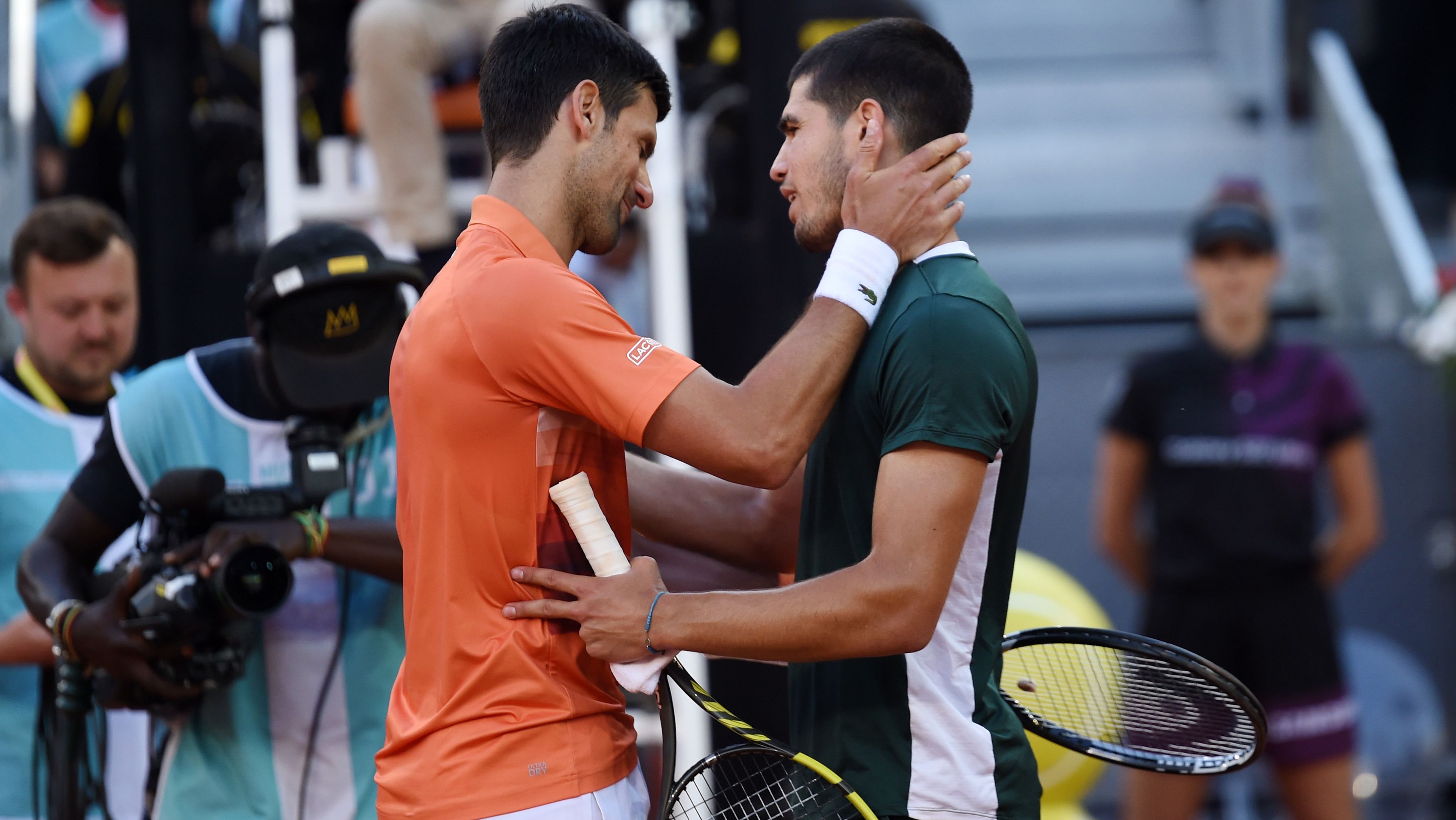 Novak Djokovic of Serbia and Carlos Alcaraz of Spain interact.