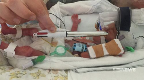 Mila weighed less than 600 grams when she was born and was barley longer than a pen. (9NEWS)