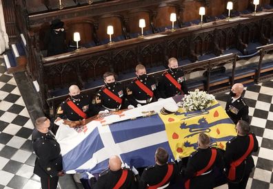 Queen Elizabeth II watches as the coffin of the Duke of Edinburgh is placed St George's Chapel, Windsor Castle, Berkshire during his funeral service. Picture date: Saturday April 17, 2021. PA Photo. See PA story FUNERAL Philip. Photo credit should read: Jonathan Brady/PA Wire