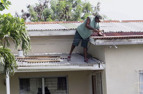 A homeowner makes last minute repairs to his roof in preparation for Hurricane Irma, in St. John's, Antigua and Barbuda. (AP)