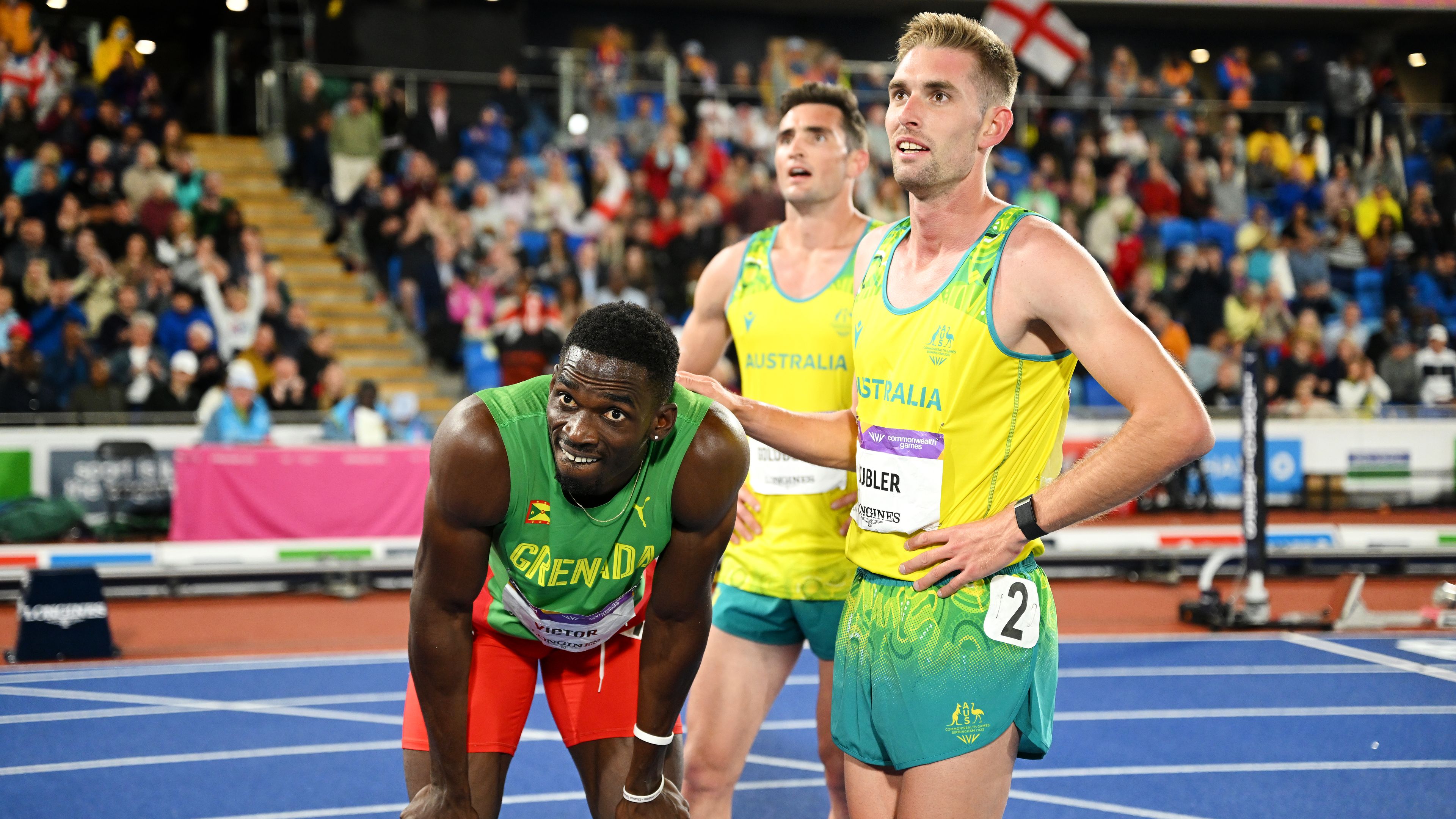 Lindon Victor, Daniel Golubovic and Cedric Dubler await the final results of the men&#x27;s decathlon. 