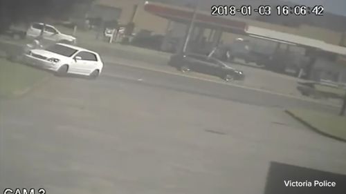 CCTV shows a white car crashing into a man. (9NEWS)