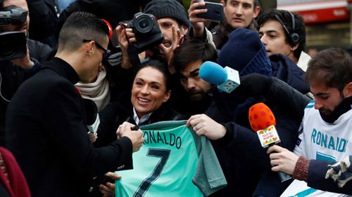 Ronaldo signed autographs for fans as he left court.