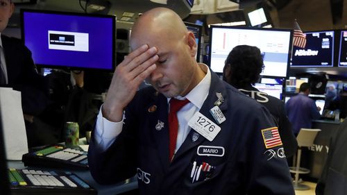 Specialist Mario Picone works on the floor of the New York Stock Exchange on Wednesday.