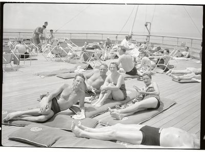 Passengers sunbake on the French ocean liner Normandie in 1937