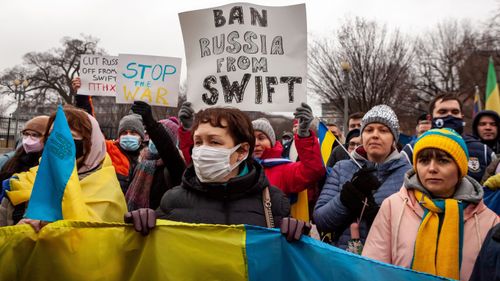 Protesters demand that Russia be banned from the SWIFT system during a rally for Ukraine at the White House.  