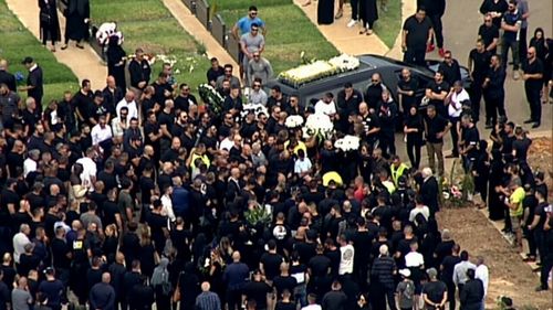 Hundreds of mourners attended the burial at Rockwood Cemetery. (AAP)