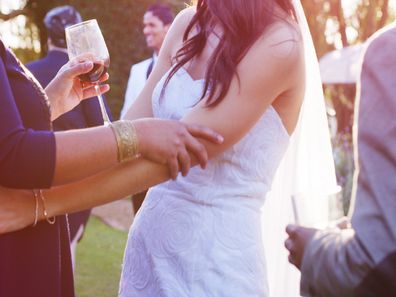 Shot of a happy young bride embracing her guest after getting married