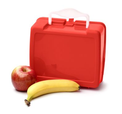 School lunch apple and banana next to red lunch box