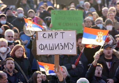 A supporter of Serbia's Novak Djokovic holds a banner that reads: ''Death to Fascism'' during protest in Belgrade, Serbia, Friday, Jan. 7, 2022. 