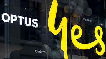 Optus logo and Yes sign in shop window (Getty)