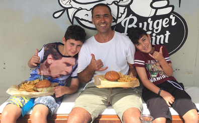 Yoav with his boys eating burgers